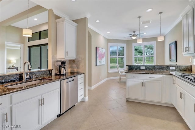 kitchen with white cabinets, appliances with stainless steel finishes, decorative light fixtures, and sink