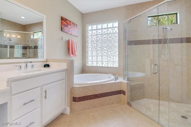 bathroom featuring tile patterned flooring, vanity, shower with separate bathtub, and a wealth of natural light