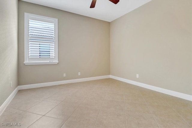 empty room featuring ceiling fan and light tile patterned flooring