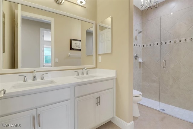 bathroom with tile patterned floors, toilet, vanity, and walk in shower