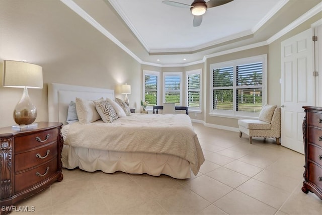 tiled bedroom with a tray ceiling, ceiling fan, and crown molding