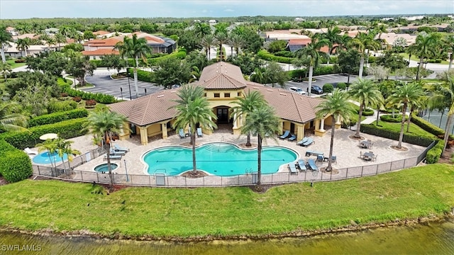 view of swimming pool with a water view and a patio