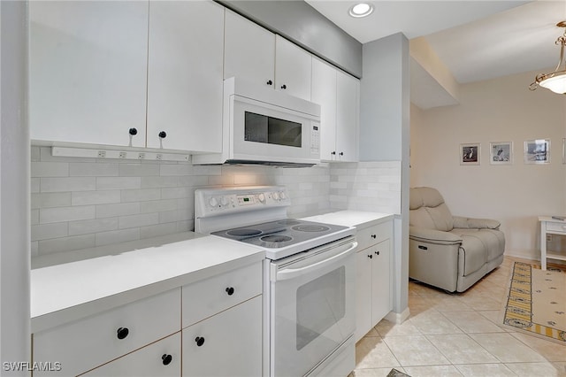 kitchen featuring white appliances, decorative backsplash, light tile patterned floors, decorative light fixtures, and white cabinetry