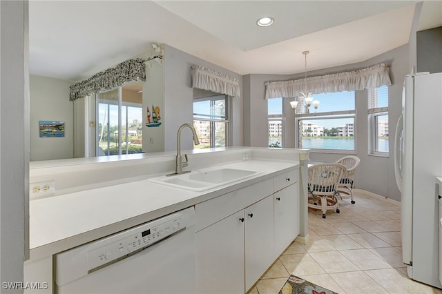 bathroom featuring tile patterned flooring, a water view, sink, and a chandelier