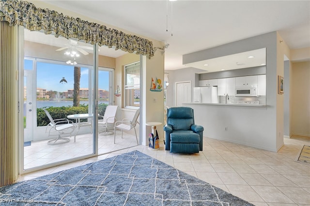 sitting room featuring ceiling fan and light tile patterned flooring