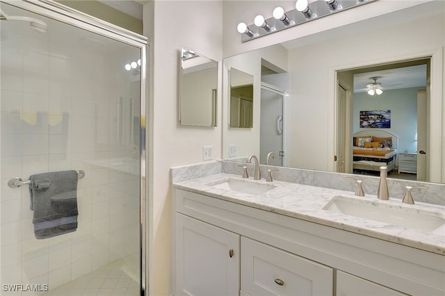 bathroom with ceiling fan, vanity, and walk in shower