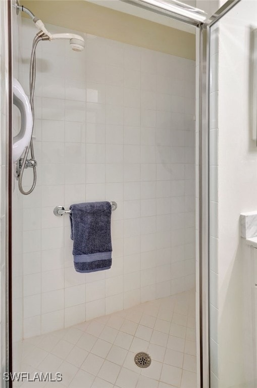 bathroom with vanity and a shower with door