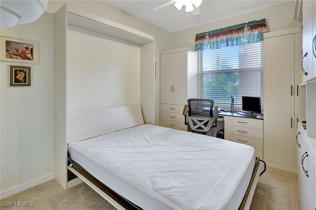 bedroom with ceiling fan and light carpet