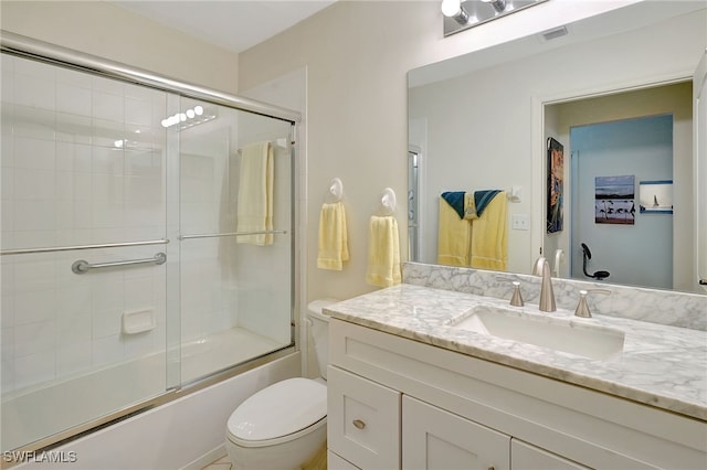 full bathroom featuring vanity, toilet, and enclosed tub / shower combo