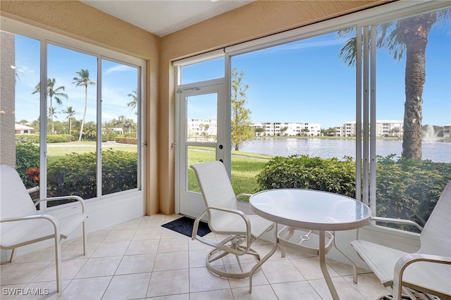 sunroom / solarium featuring a water view