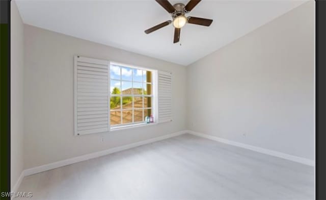 unfurnished room with ceiling fan and vaulted ceiling