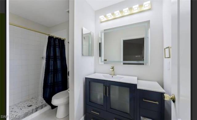 bathroom featuring curtained shower, vanity, tile patterned floors, and toilet