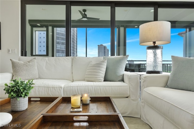 living room with hardwood / wood-style flooring and ceiling fan