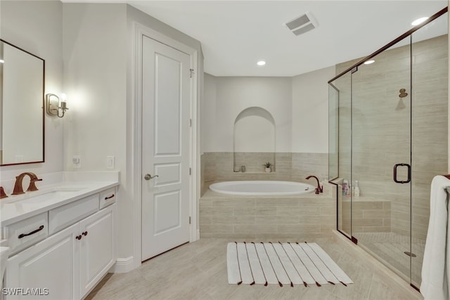 bathroom featuring plus walk in shower, tile patterned floors, and vanity