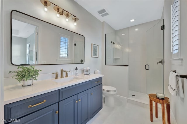 bathroom featuring vanity, toilet, tile patterned floors, and an enclosed shower