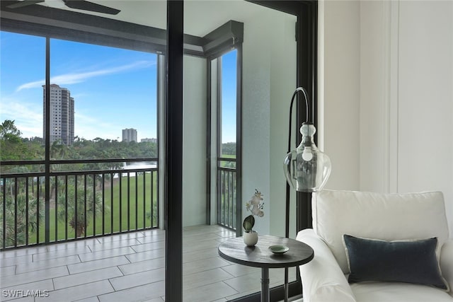 sunroom with a water view and a healthy amount of sunlight