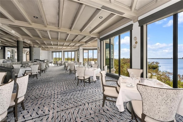 sunroom / solarium featuring coffered ceiling and a water view