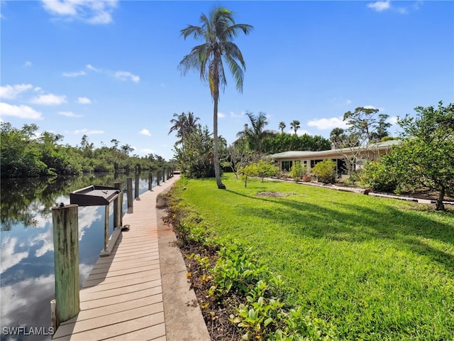 view of dock featuring a yard and a water view