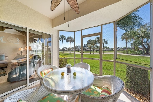 sunroom / solarium featuring ceiling fan