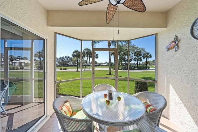 sunroom featuring ceiling fan