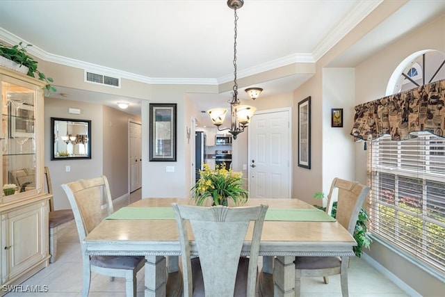 tiled dining area with ornamental molding and an inviting chandelier