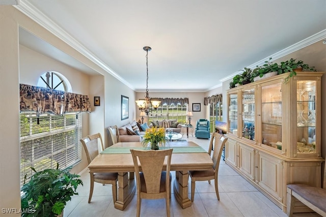 tiled dining room with crown molding and an inviting chandelier