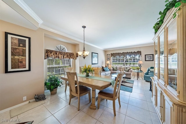 dining room with ornamental molding, a chandelier, and light tile patterned floors