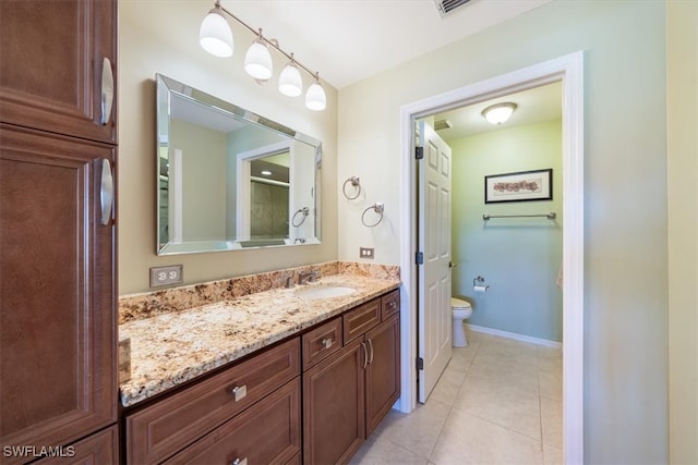 bathroom with an enclosed shower, vanity, tile patterned floors, and toilet