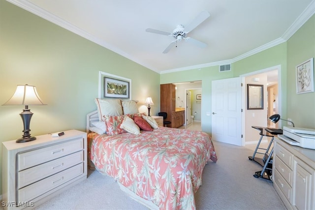 carpeted bedroom featuring ensuite bathroom, ceiling fan, and crown molding