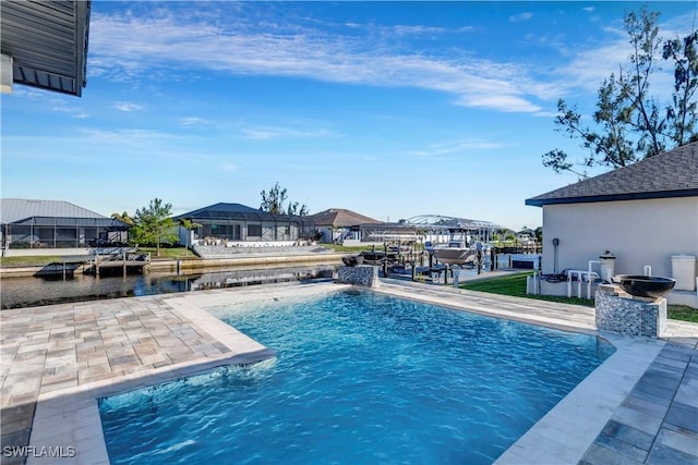 view of pool featuring a patio, a water view, and pool water feature