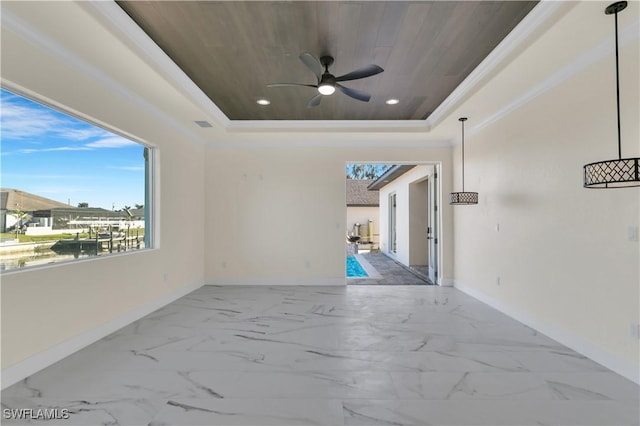 empty room with ceiling fan, wooden ceiling, and a tray ceiling