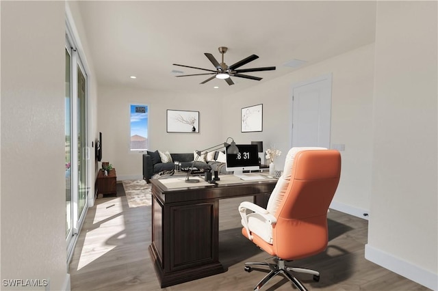 office space featuring ceiling fan and light hardwood / wood-style flooring