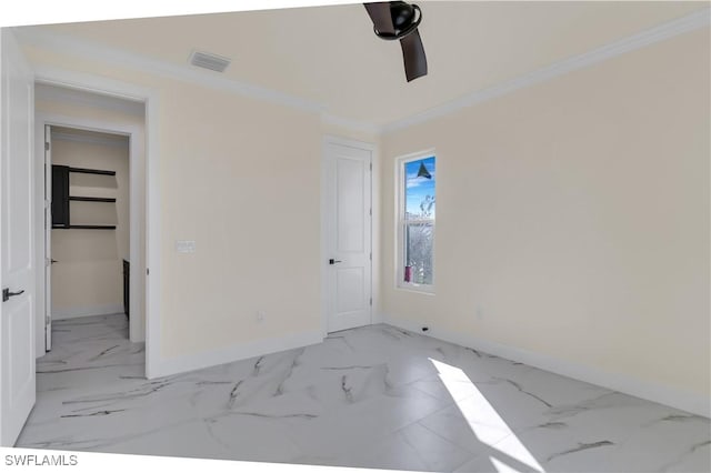 empty room with ceiling fan and ornamental molding