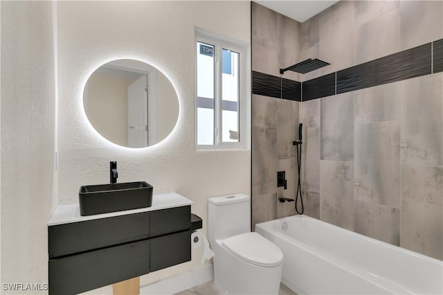 full bathroom with vanity, tiled shower / bath combo, and toilet