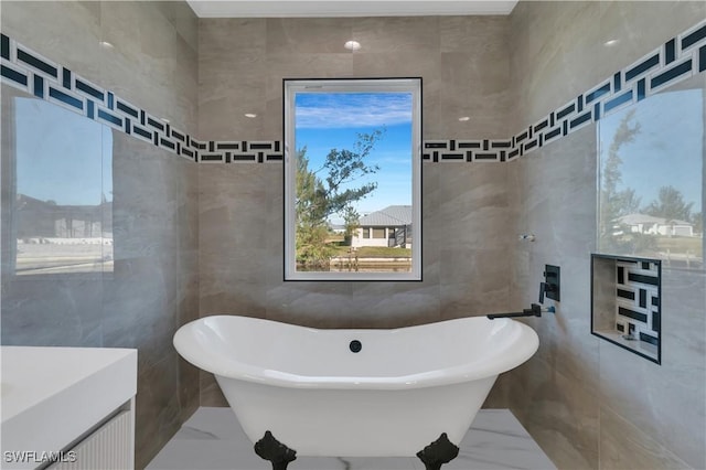 bathroom featuring a tub to relax in and tile walls