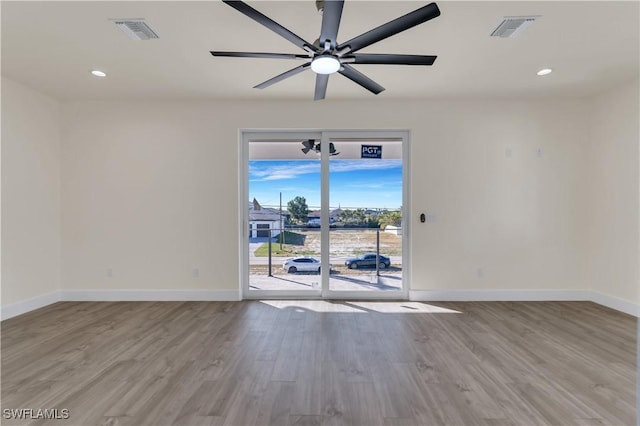 unfurnished room with ceiling fan and light wood-type flooring