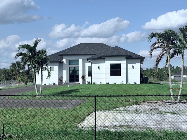 prairie-style house with a front yard and central AC