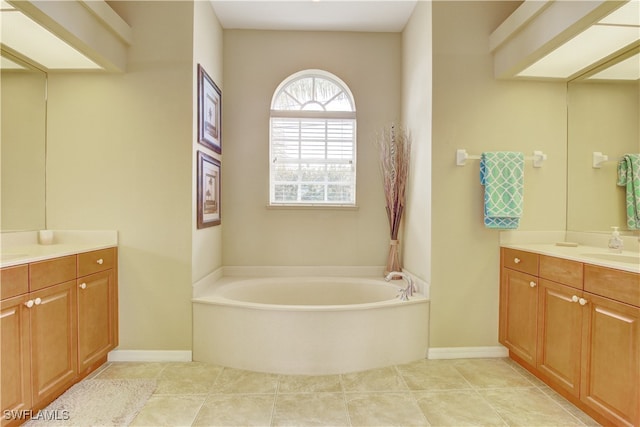 bathroom with vanity, tile patterned flooring, and a bathing tub