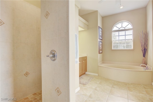 bathroom with shower with separate bathtub, vanity, and tile patterned floors