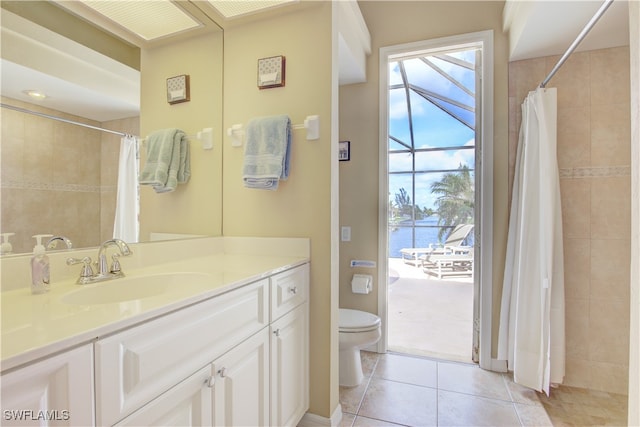 bathroom featuring toilet, vanity, a water view, and tile patterned flooring