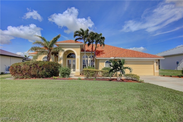 mediterranean / spanish-style house with a garage and a front lawn