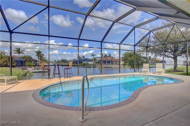 view of swimming pool featuring a patio area, a water view, and a lanai