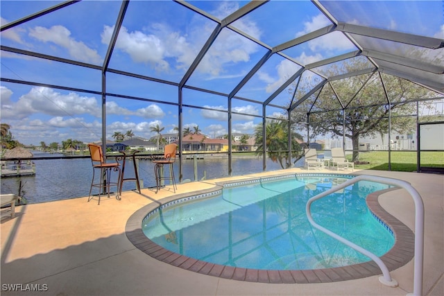 view of swimming pool featuring a lanai, a water view, and a patio area