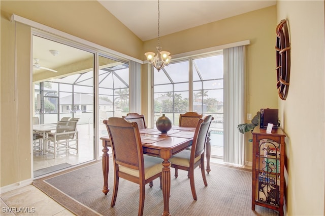 dining space featuring a chandelier, lofted ceiling, and light tile patterned floors