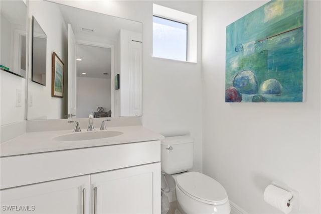 bathroom featuring vanity and toilet