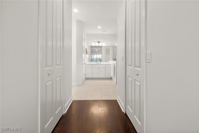 corridor featuring light wood-type flooring and washer / clothes dryer