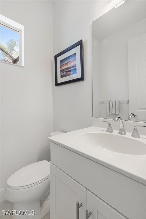 bathroom featuring vanity and toilet