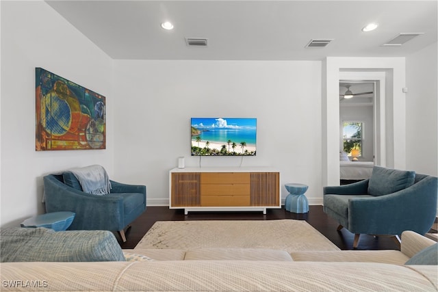 living room with dark hardwood / wood-style floors and ceiling fan