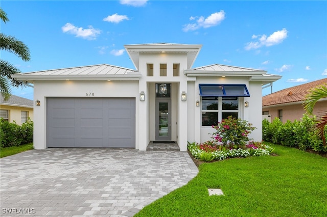 view of front of house with a front lawn and a garage