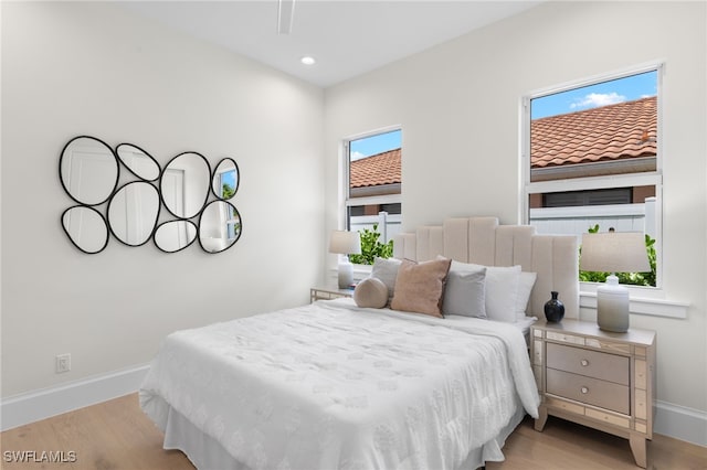 bedroom featuring light wood-type flooring, baseboards, and recessed lighting